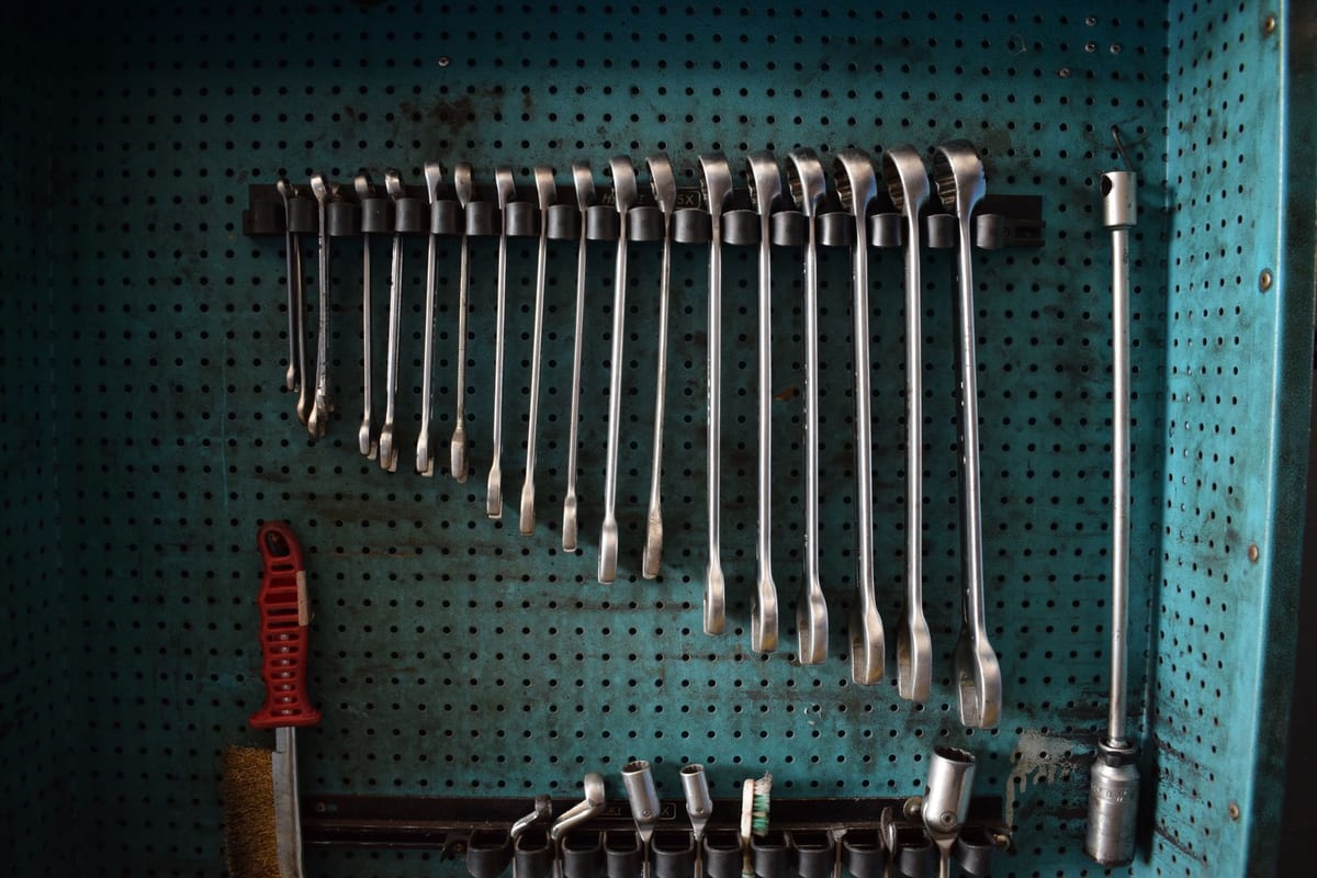 Neatly arranged wrenches on a workshop tool board